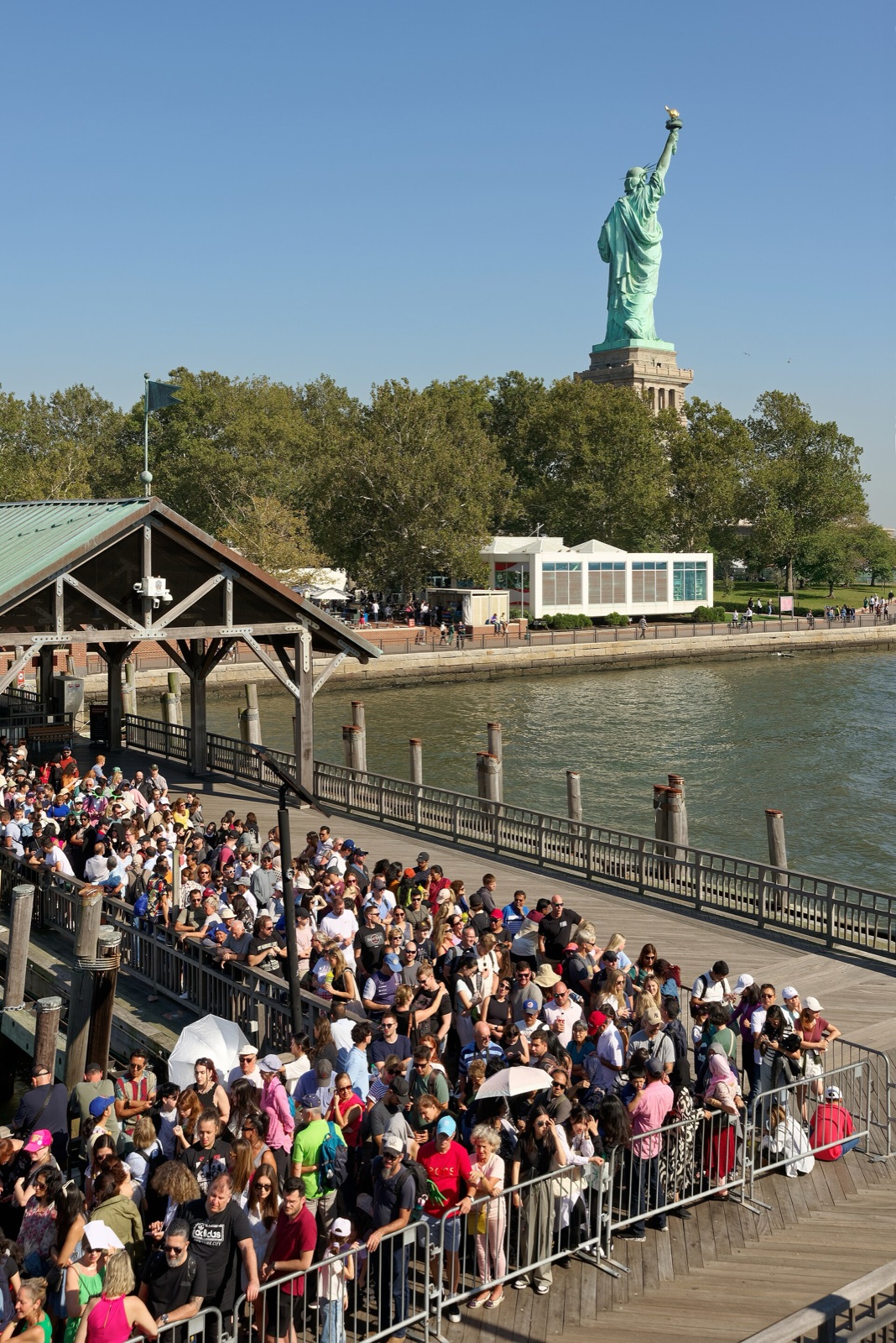 Passenger ferry at the Liberty Island terminal with the statue nearby