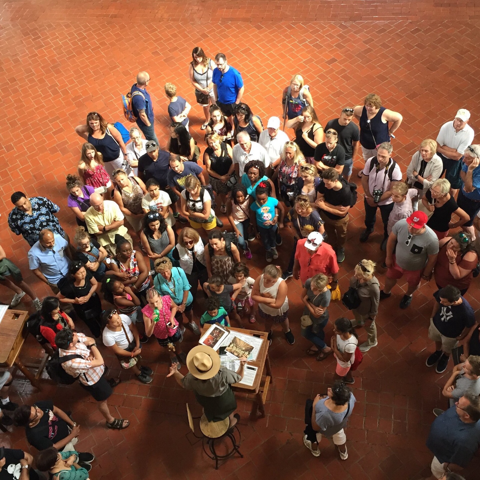 Visitors gathered beneath the vaulted ceiling of the Ellis Island Great Hall