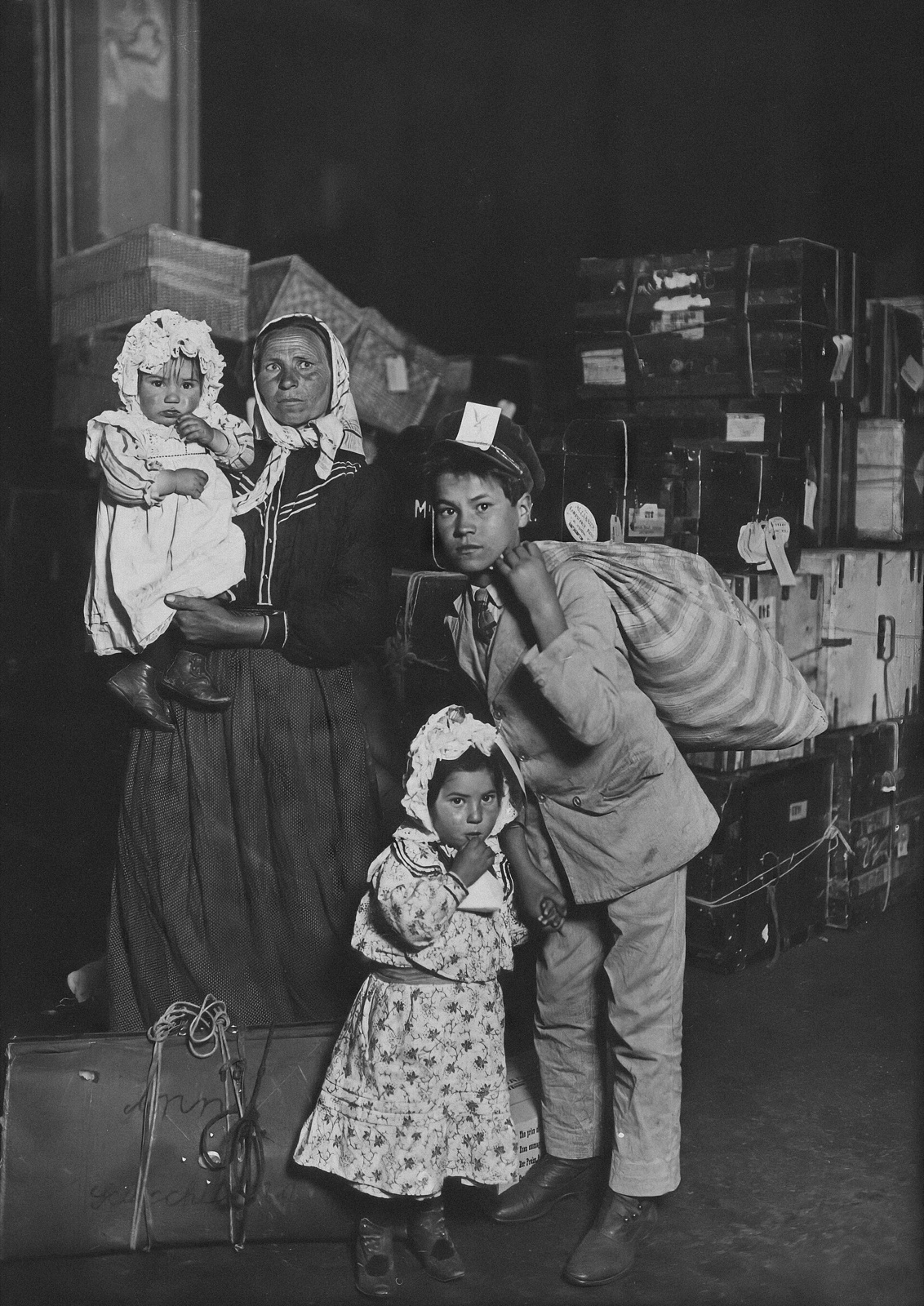 Italian immigrant family photographed in the Ellis Island baggage room in 1905
